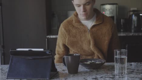 man eating breakfast alone - close up