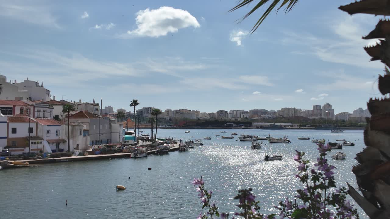 Small boats on shimmering water near Ferragudo Portugal
