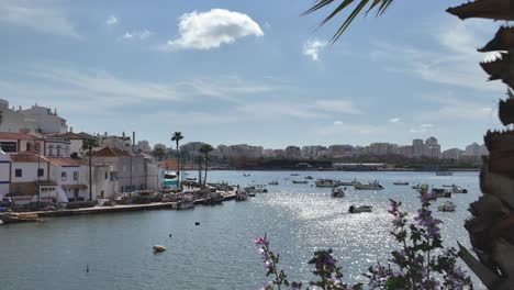 small boats on shimmering water near ferragudo portugal