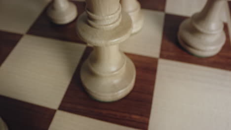 tilt up shot reveals white queen chess piece a leadership concept, closeup view