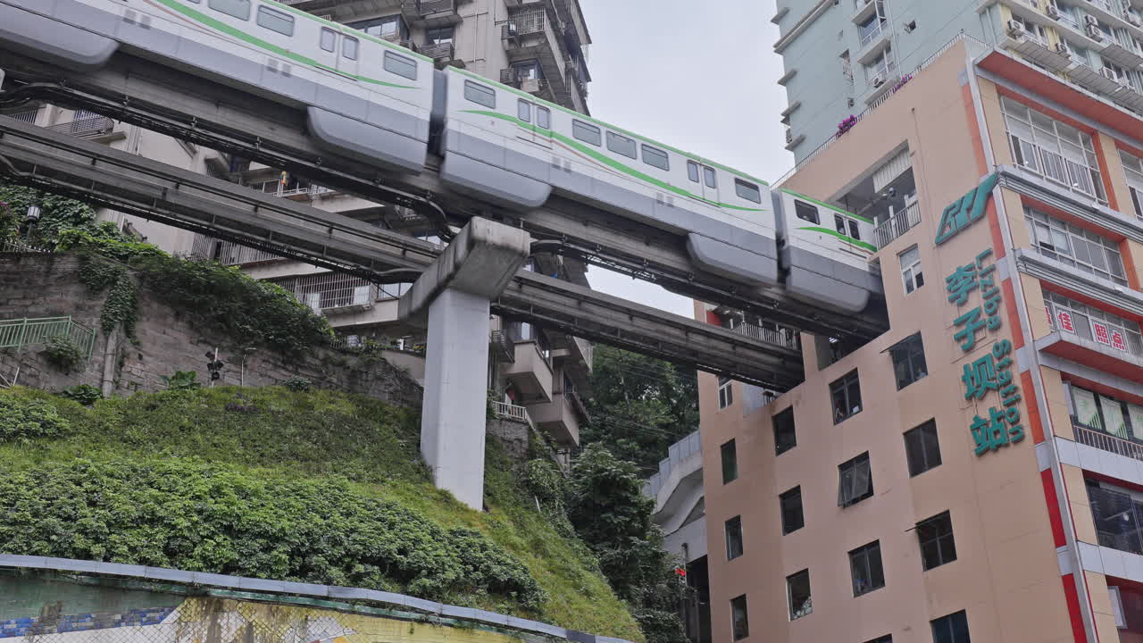 CHONGQING, CHINA - 28 MAY 2025 : train enters liziba station inside a building on bridge in Chongqing china