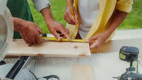 grandfather teaching grandson woodworking