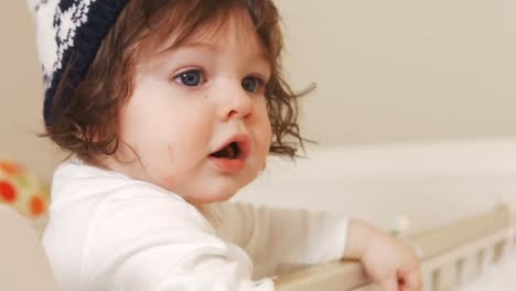 Close-up-of-baby-girl-in-baby-cot