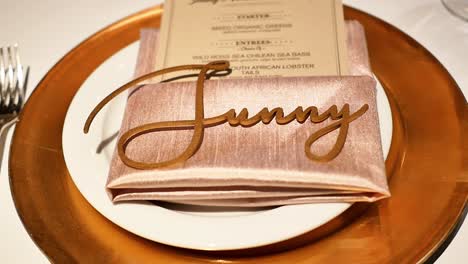 close up of dinner plate and tableware at wedding, decoration spelling sunny