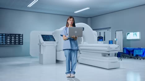 full body of asian female doctor having a serious while working on a laptop with mri machine