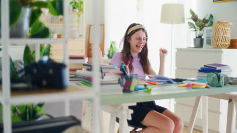 a young girl does her math homework and uses a calculator while studying