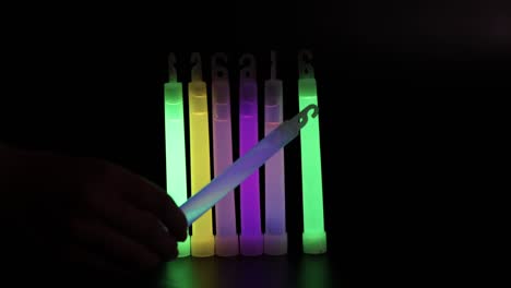 hand activating and displaying colorful glowsticks