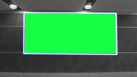 empty blank widescreen billboard with green screen, alpha channel. chroma key frame on airport hall, big banner for marketing.
