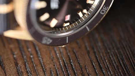 luxury wristwatch on its side, second hand is moving by, beautiful rare bronze and brown face