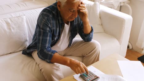 tensed senior man checking the bills