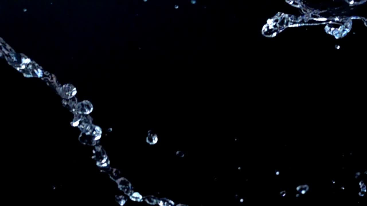 Water on a black background. Slow motion