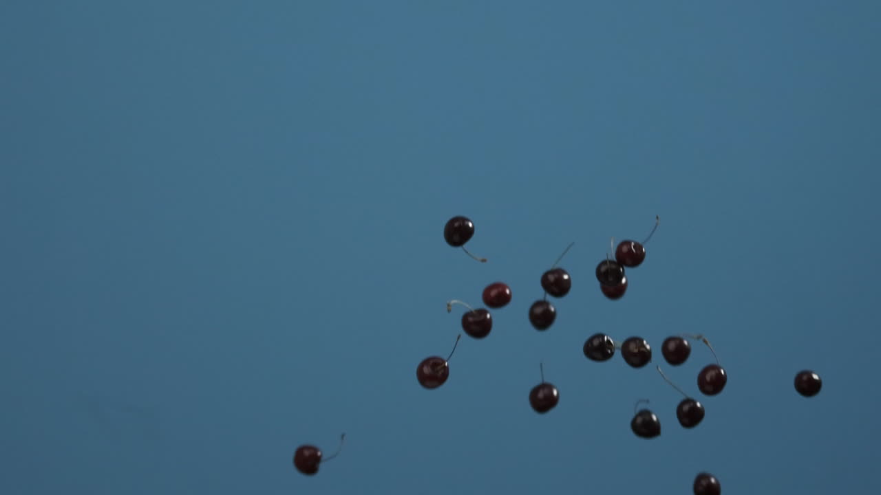 Cherries Falling on a Blue Background