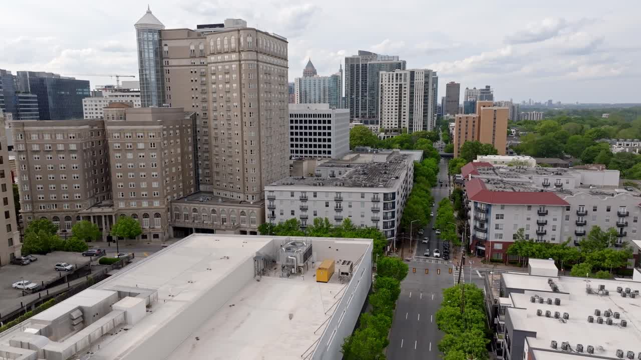 Upscale neighbourhood with outdoor units of air conditioning systems at roof, tree lined streets and park, Atlanta, Georgia, Drone shot