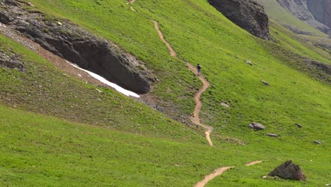 woman hiking a steep trail in southern colorado