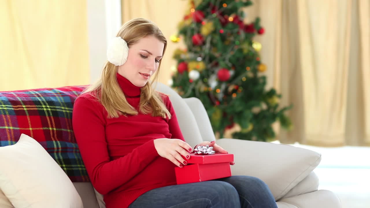 una rubia embarazada festiva con botas de bebé