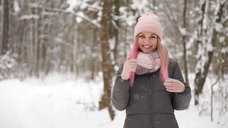 happy beautiful woman in casual style rolling with her hands up while it is snowing on the nice town square in the winter time. outdoor. portrait shot