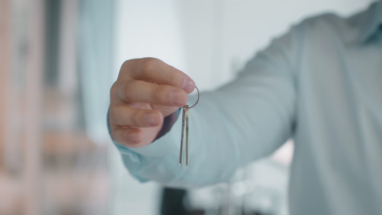 Hand holding house keys