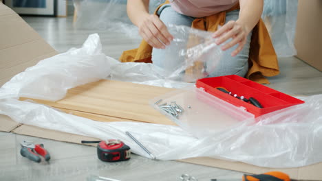woman assembling furniture