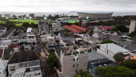 drone fly above The Cape Town Stadium football and rugby union stadium in South Africa illuminated at night before a sport event