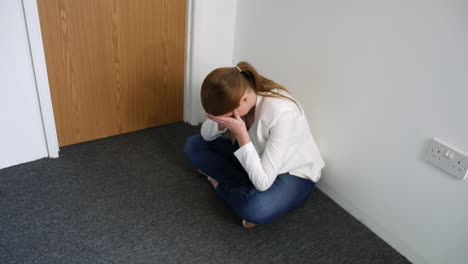 A-lonely-depressed-young-woman-sitting-on-the-floor