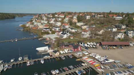 small boats in marina and boatyard near exclusive residential homes