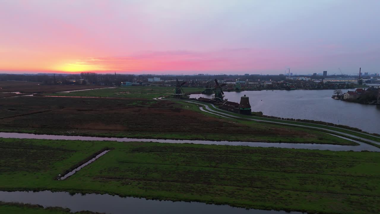 Dronevideo of the Windmills of zaanse schans (close to Amsterdam) in the early dawn lights.
