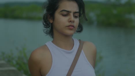 Beautiful-Indian-model-girl-enjoying-a-day-out-on-a-lake---Relaxed-woman-tourist