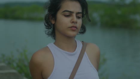 beautiful indian model girl enjoying a day out on a lake - relaxed woman tourist