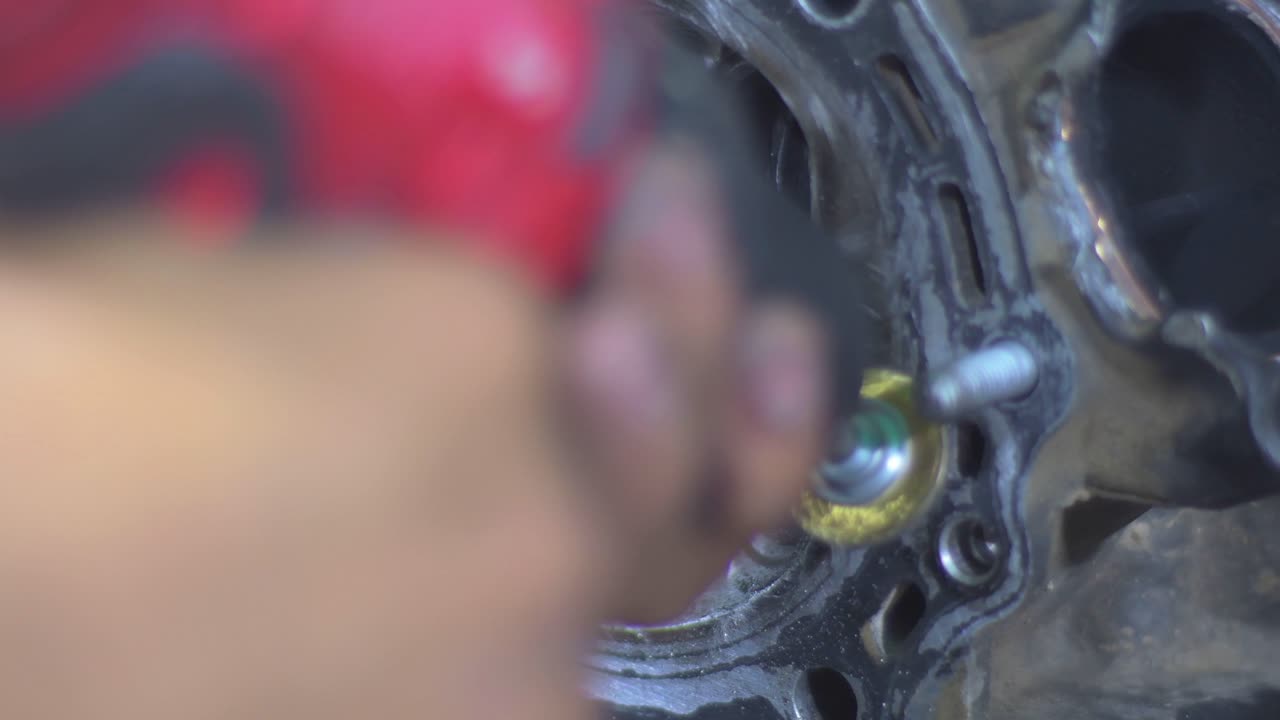 Engine Intake and Exhaust Valves. Close-up of motorbike engine cylinder head being cleaned with dremel tool,