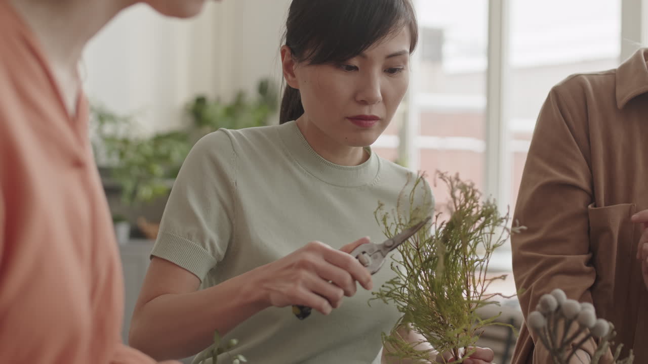 Woman Trimming Decorative Plants with Secateurs