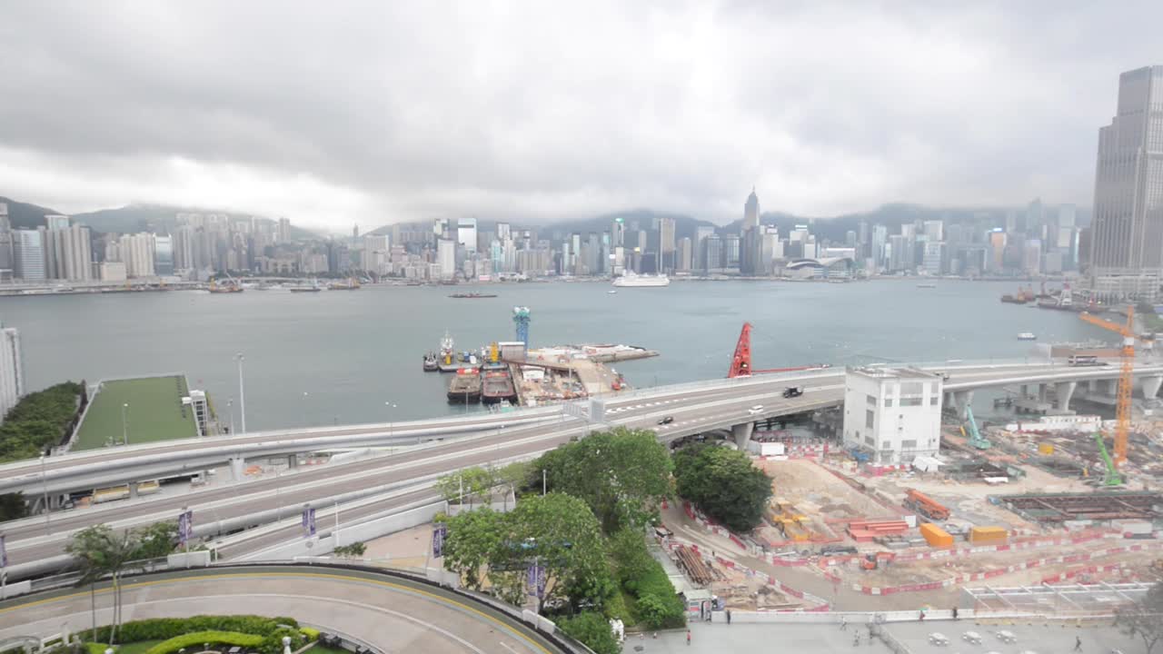 A time lapse of Victoria harbour with highway and construction site.