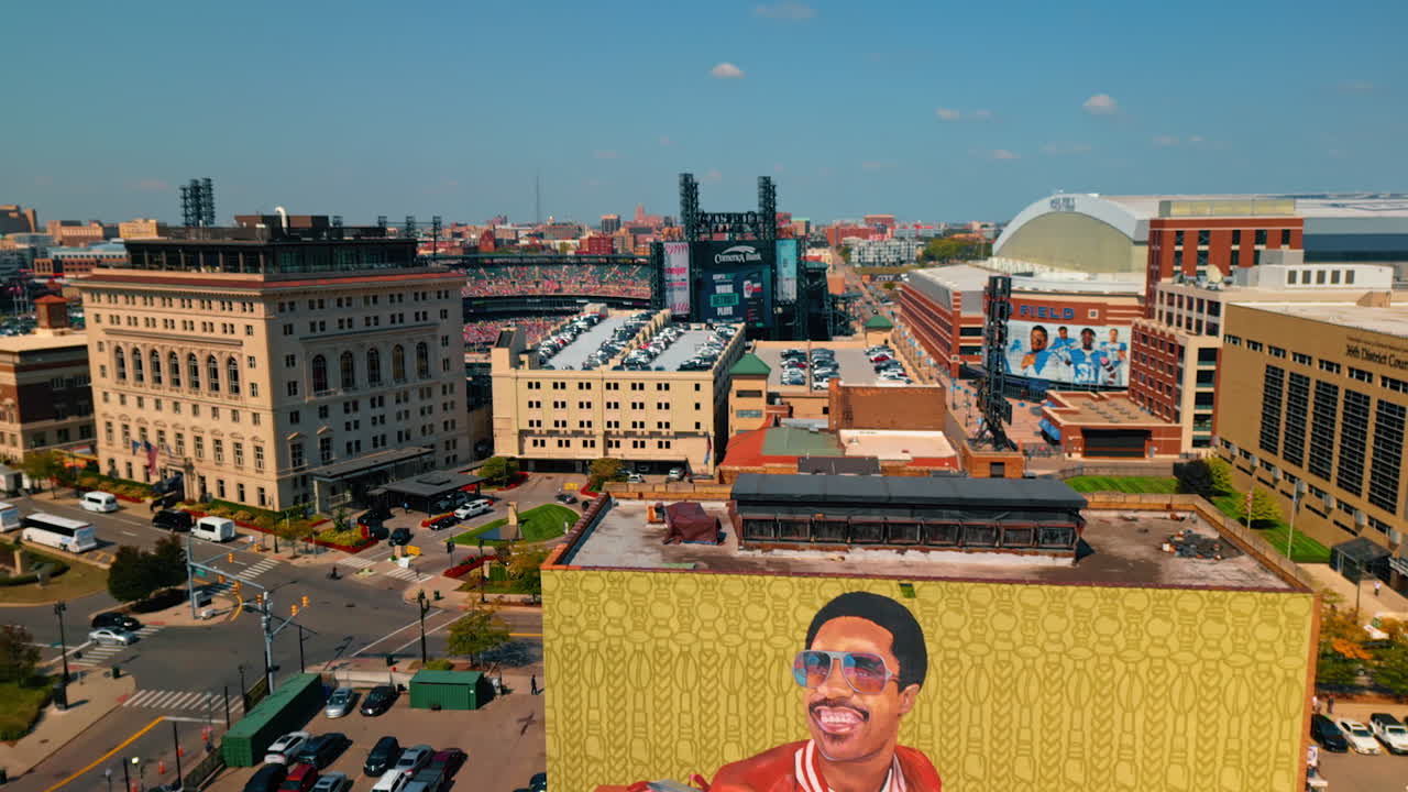 Detroit, USA, 28 July 2025: High-rise building with a mural of a musician. Many of parking lots near the building and on the roofs of the buildings around. Detroit, Michigan, USA. Aerial view