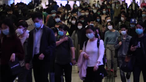 crowd of people wearing face masks in the city
