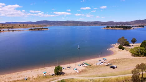 boating at the calm waters of jindabyne lake on a sunny day in nsw, australia