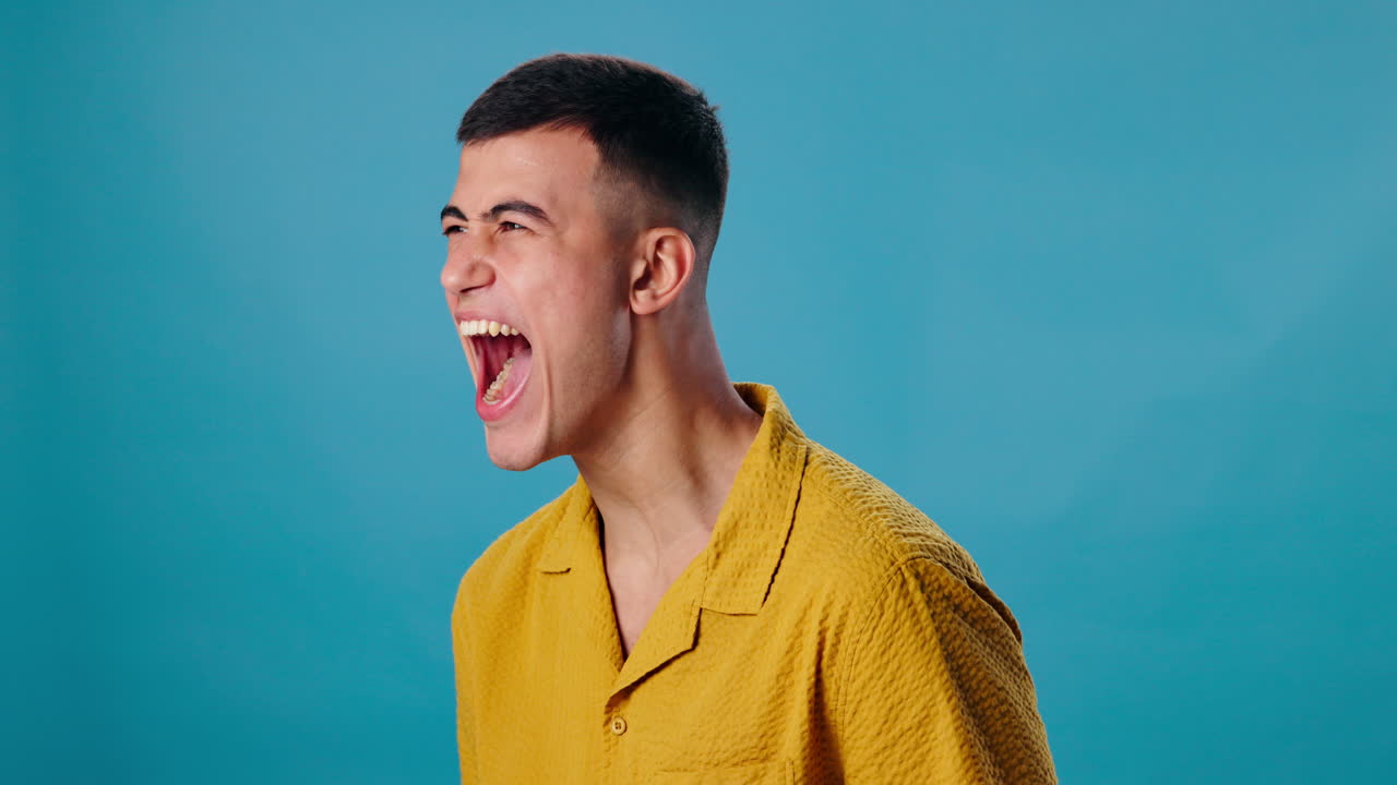 Man yelling in a yellow shirt