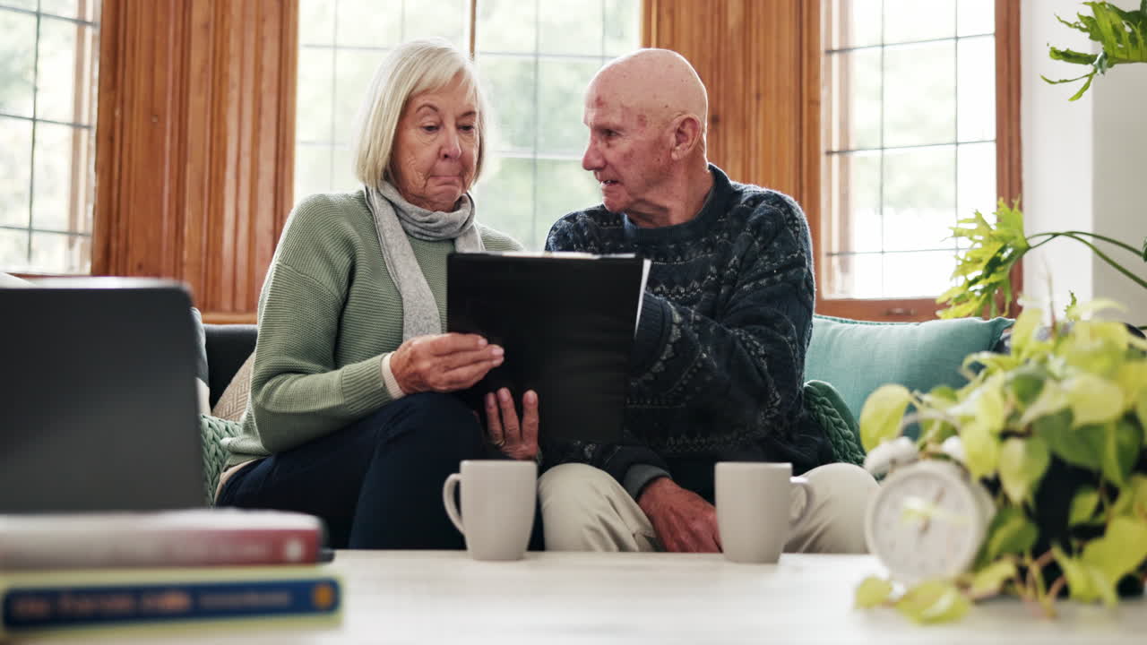 Finance, documents and senior couple on a sofa