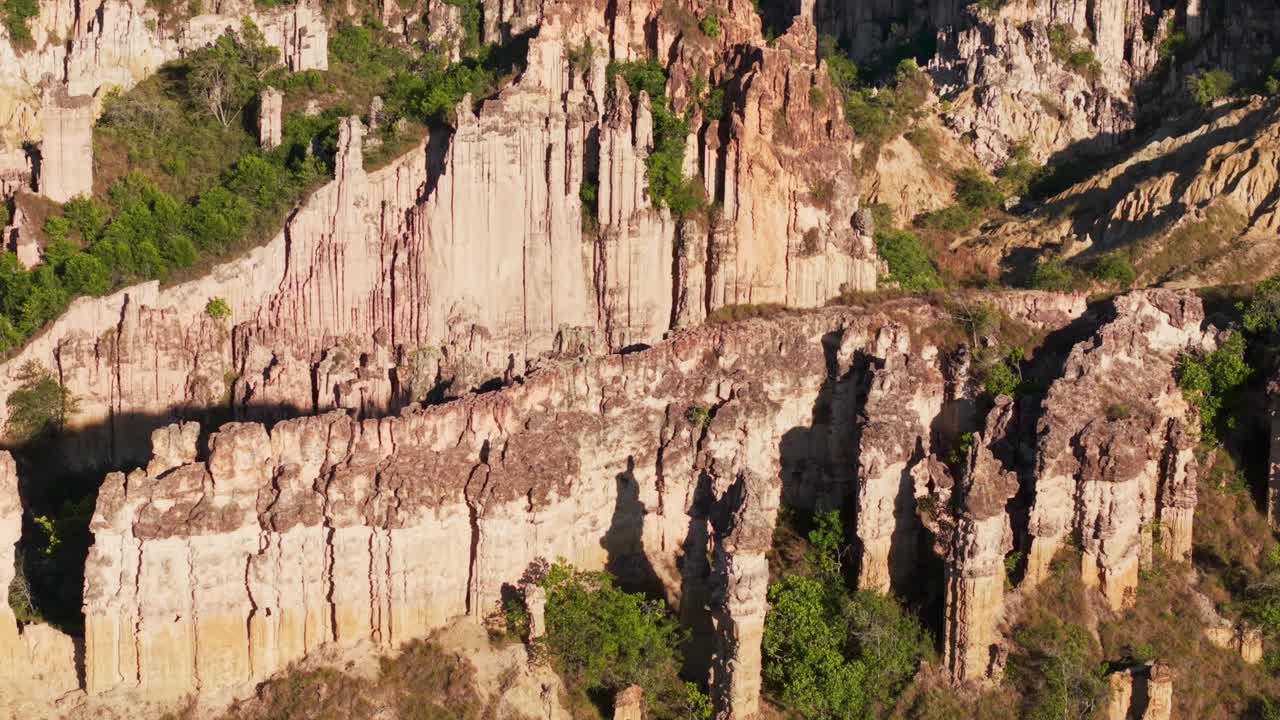 Aerial tilt down view of the stunning rock formations and eroded columns in los estoraques, colombia
