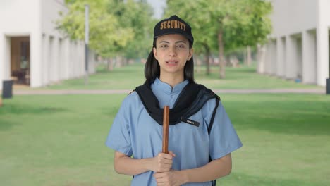 happy indian female security guard listening to someone