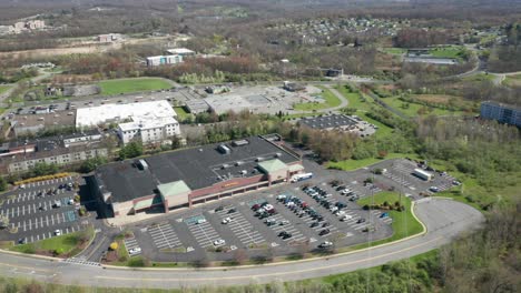 4k aerial drone footage of industrial shopping centers and strip malls in middletown new york and traffics can be seen with mountains in the background