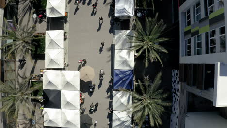 aerial view of an outdoor marketplace with tents and pedestrians