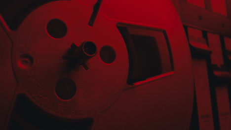 a close-up on a vintage tape recorder in a red blinking light
