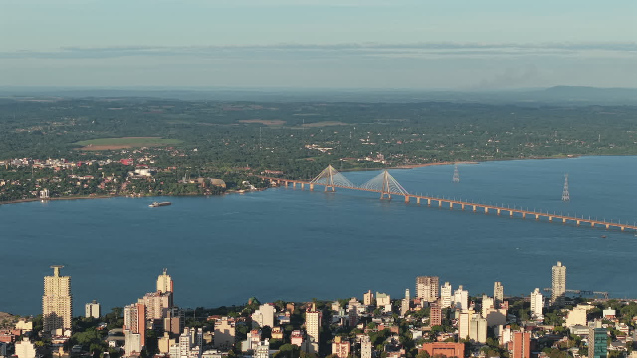 Bright aerial cityscape with International bridge and Paraná River bay over Posadas city, Misiones, Argentina.