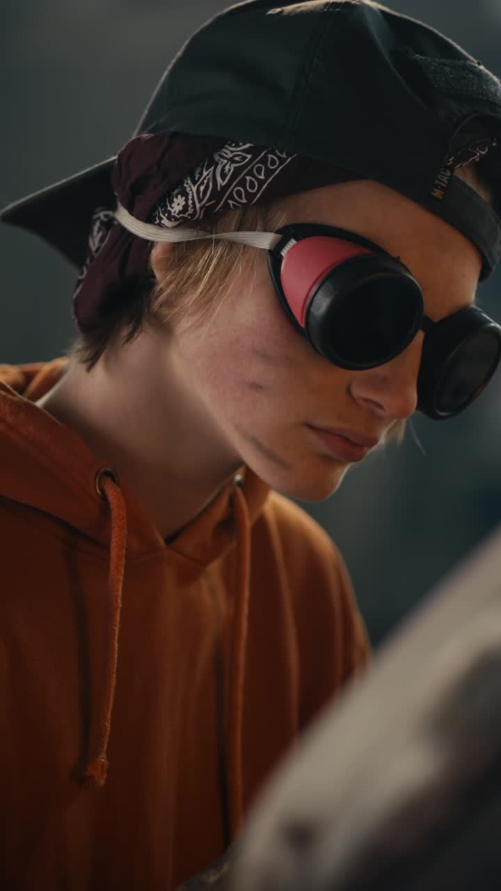 Woman wearing safety gear and focused on work