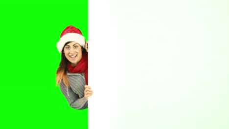 Beauty-brunette-in-santa-hat-showing-white-poster