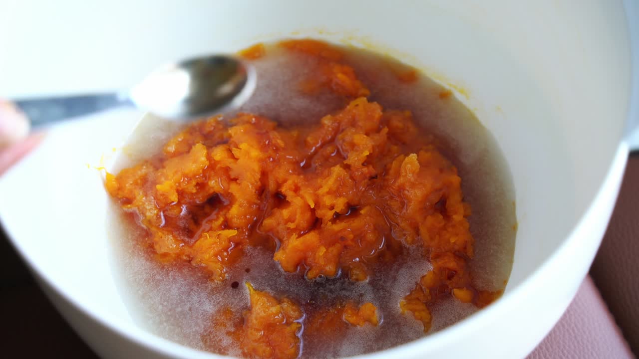 Adding ingredients to pumpkin puree roast in bowl preparing ingredients for pumpkin muffins