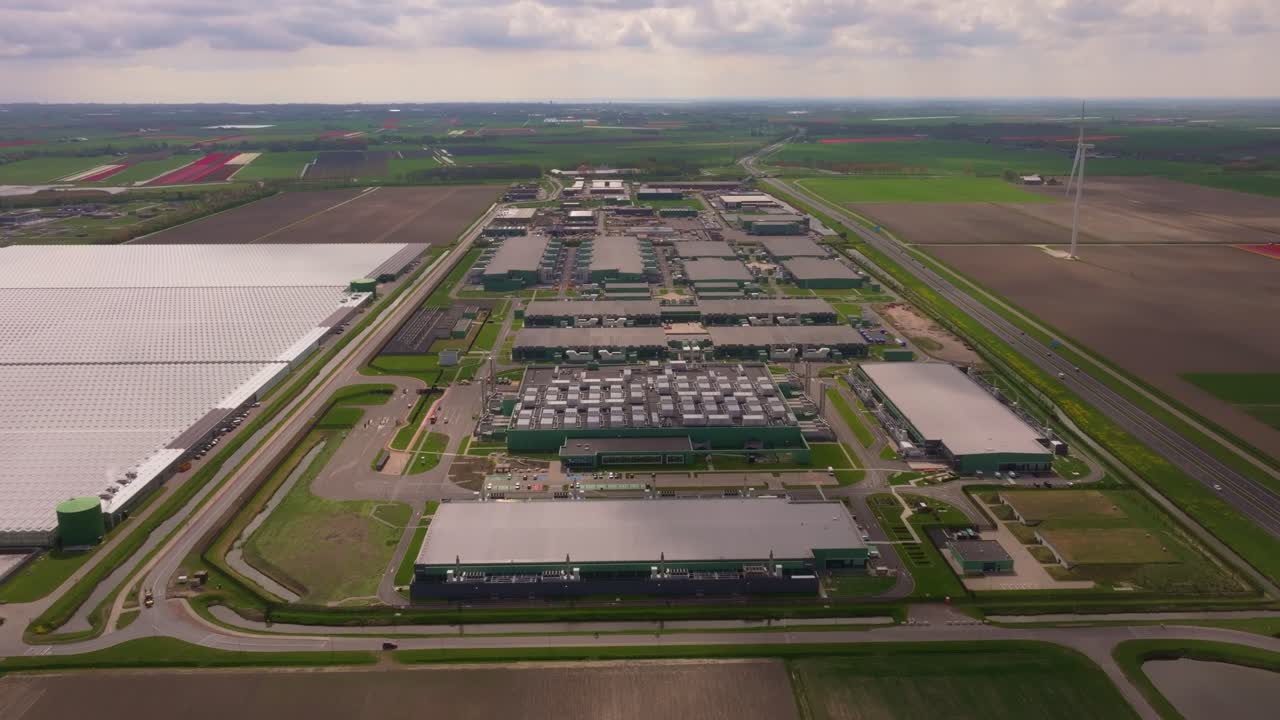 Major tech site surrounded by fields in North Holland. Aerial drone video