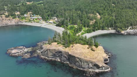 aerial view tilting down over the rosario beach cliff side in washington state