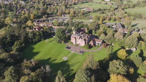 aerial view of a grand manor house set in a serene english village, with surrounding greenery enhancing the rural elegance, uk
