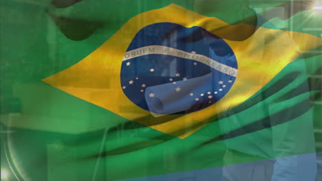 animation of flag of brasil over happy african american male architect studying blueprints