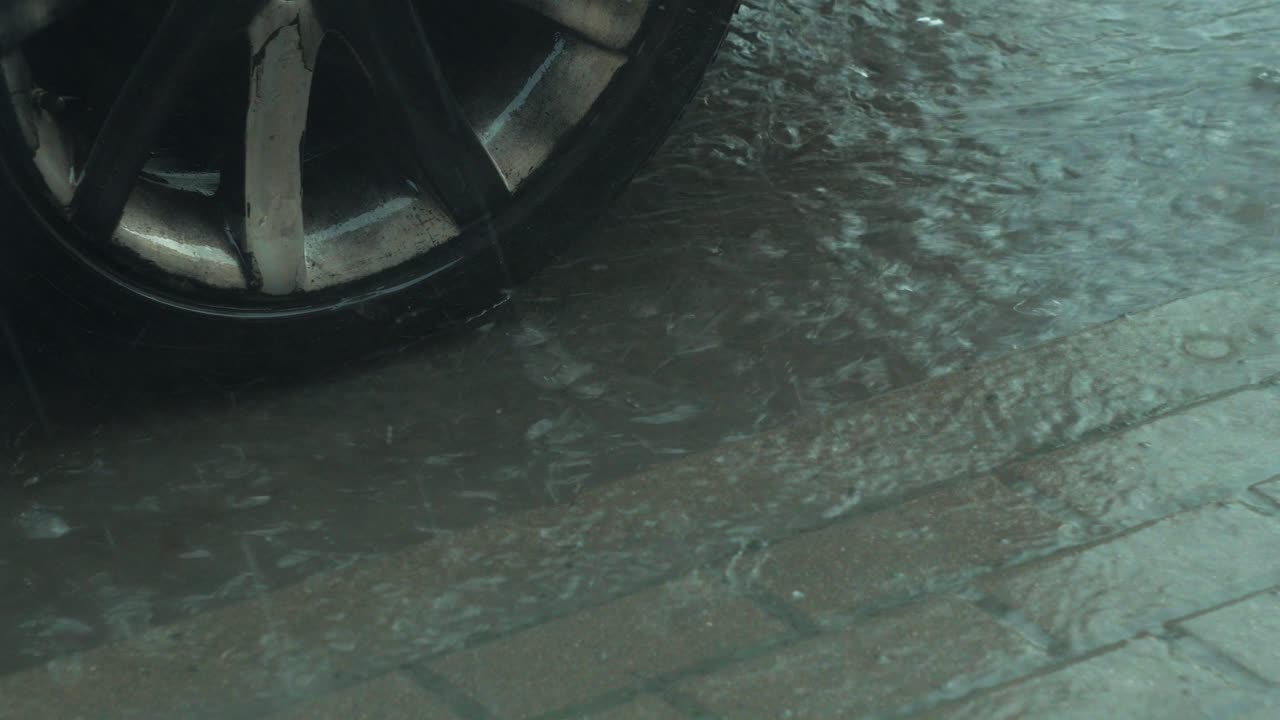 View of heavy storm hail and rain falling on a black car, nature ...